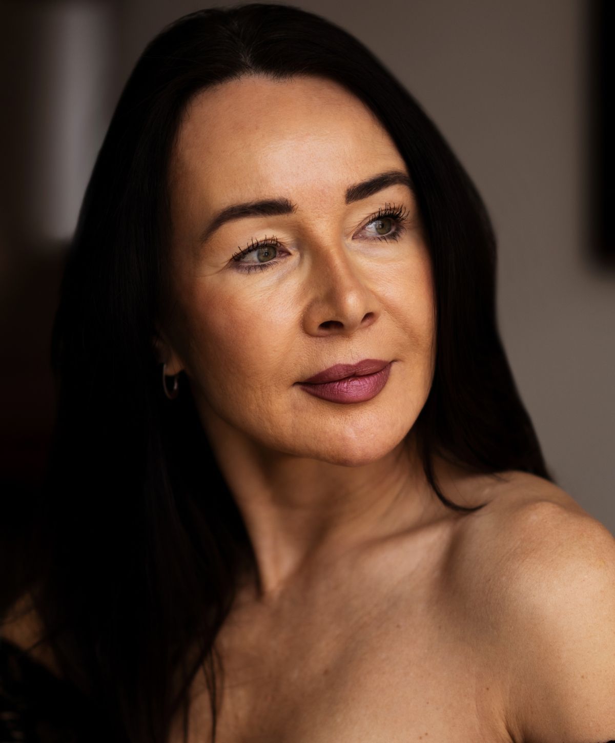 Portrait of a woman with long dark hair.