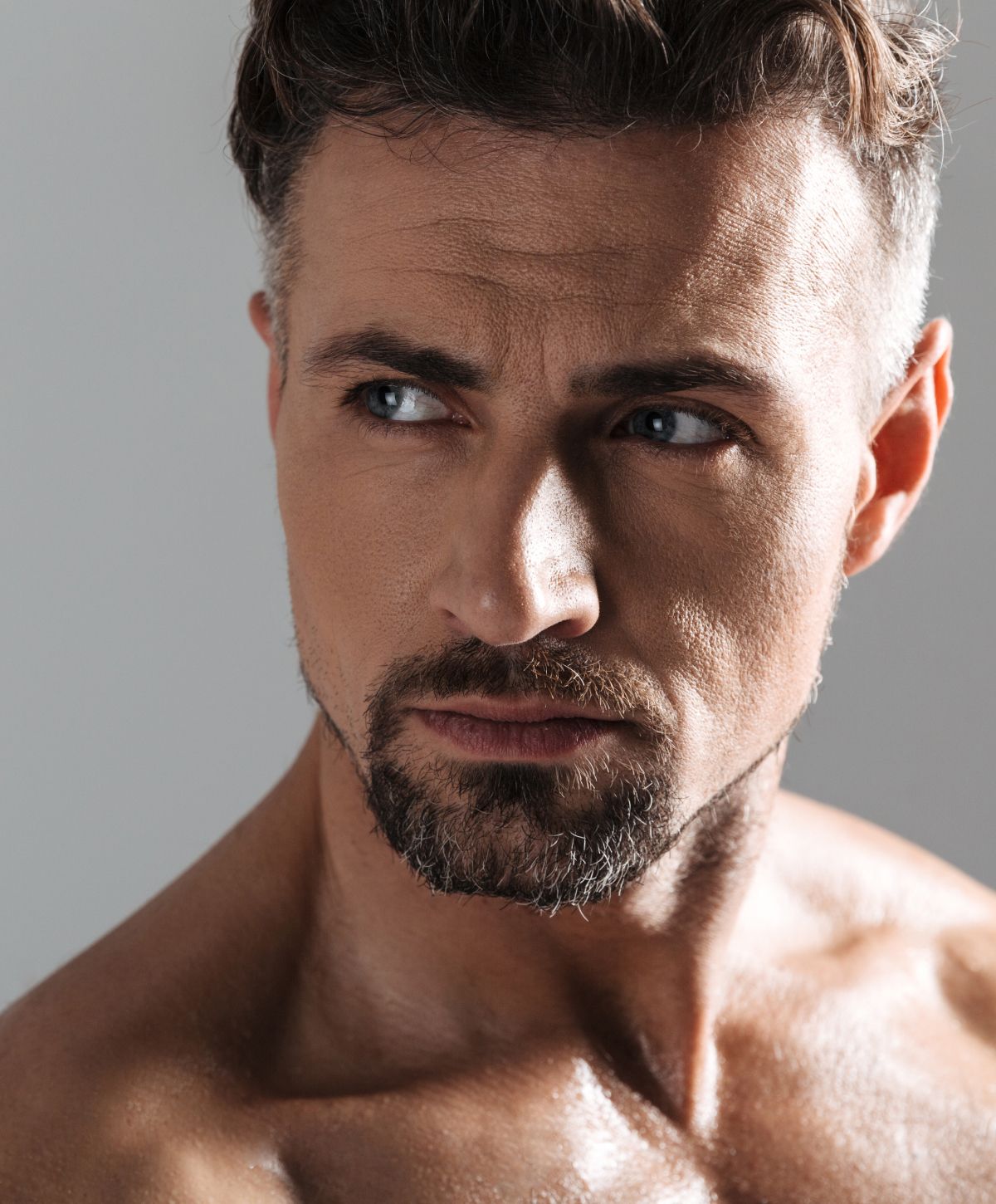 Close-up of a man with thoughtful expression.