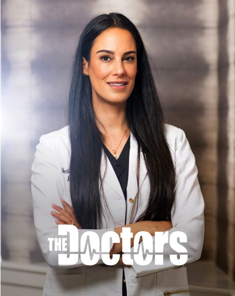 Female doctor in white coat with long hair.