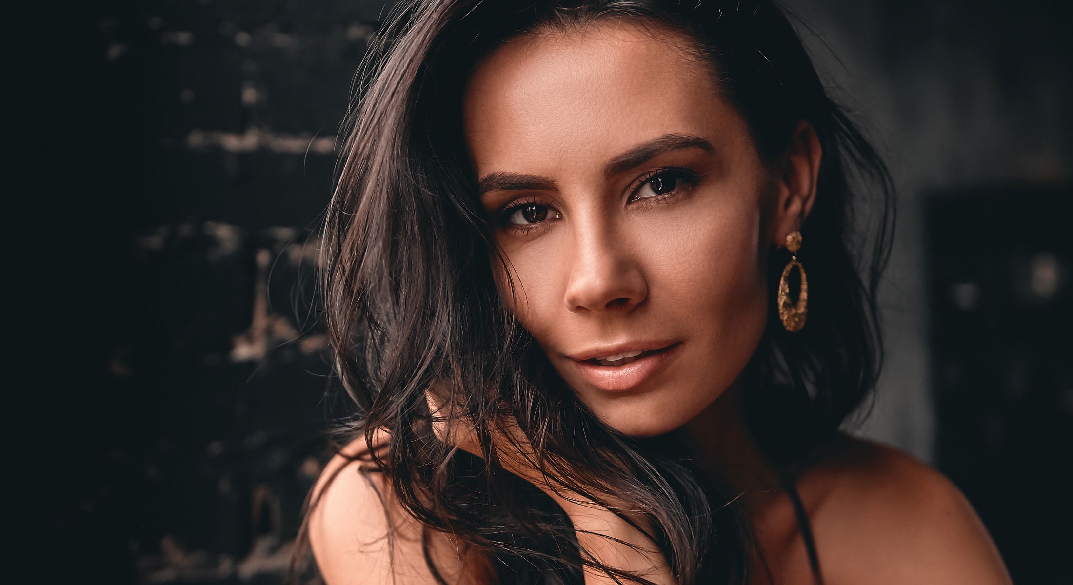 Close-up portrait of a woman with earrings.