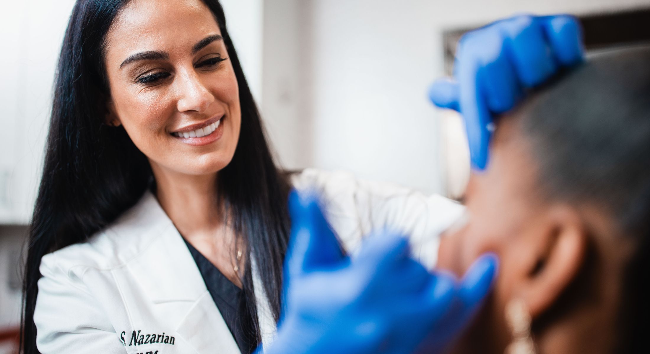 Medical professional treating a patient in clinic.
