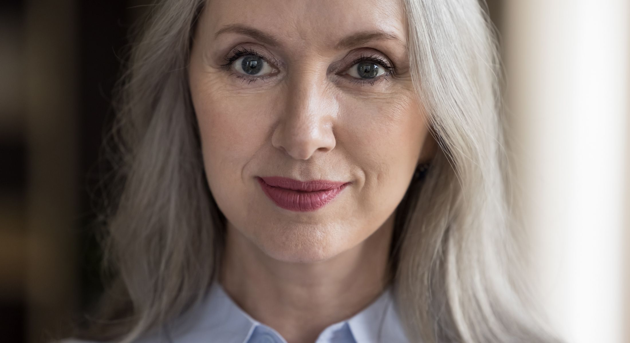 Middle-aged woman with long gray hair.